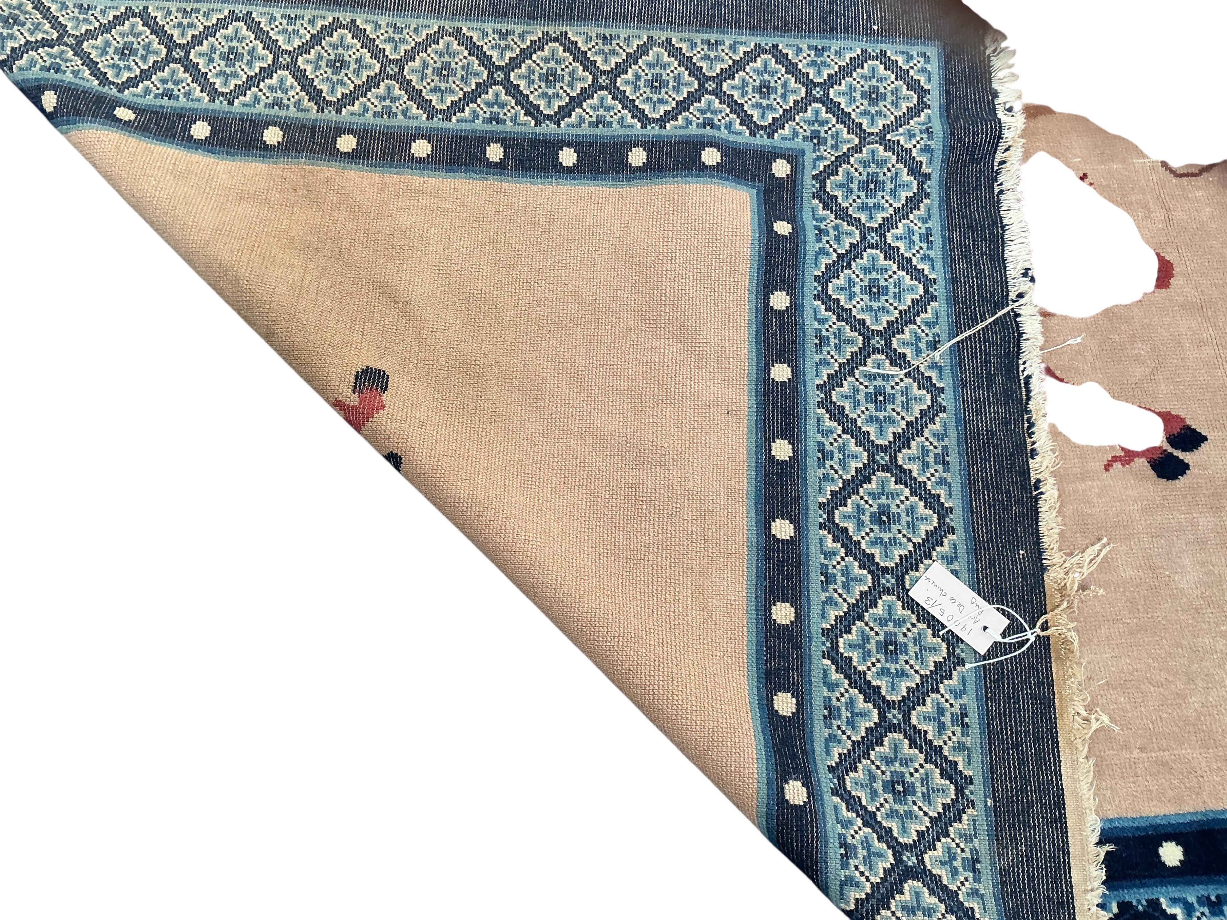 An early 20th century Chinese fawn ground rug, retailed by Liberty and Co, 248 x 154cm.
